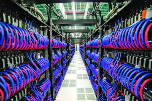 Inside the Frontier supercomputer, a network of tubes carries water to cool thousands of computer chips in the system. Photo Source: Oak Ridge National Laboratory/Hewlett Packard Enterprise